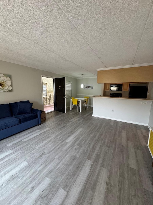 unfurnished living room featuring wood-type flooring and a textured ceiling