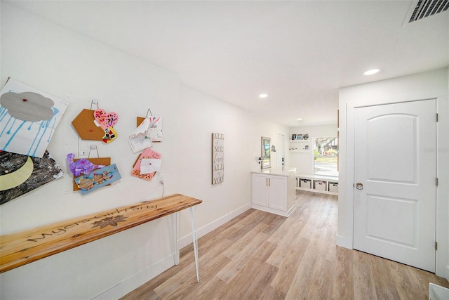 hall with light hardwood / wood-style floors