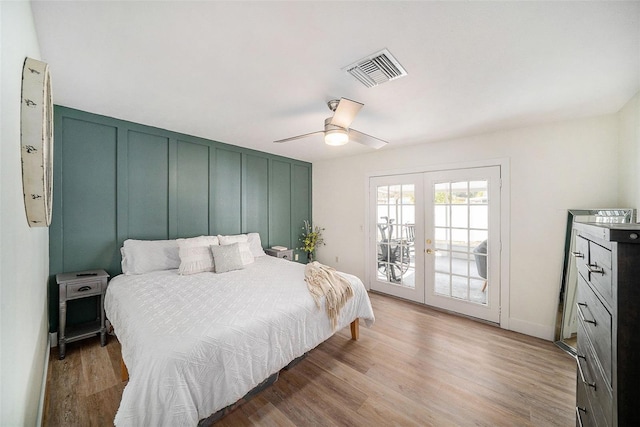 bedroom with french doors, ceiling fan, access to exterior, and hardwood / wood-style floors