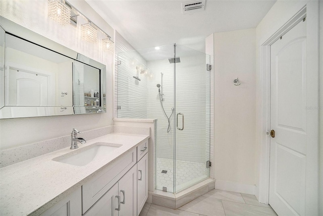 bathroom featuring vanity and a shower with shower door