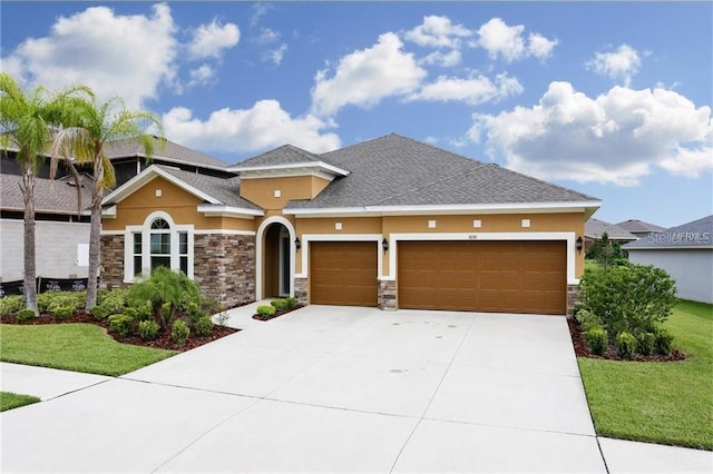 view of front of property with a garage and a front yard