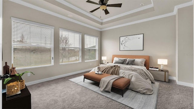 bedroom with a raised ceiling, crown molding, light colored carpet, and ceiling fan