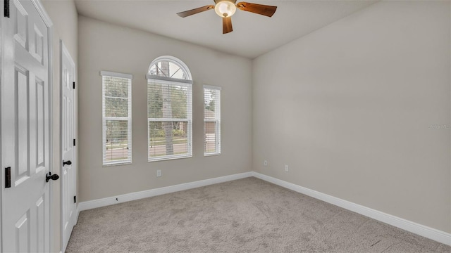 unfurnished room with ceiling fan and light carpet