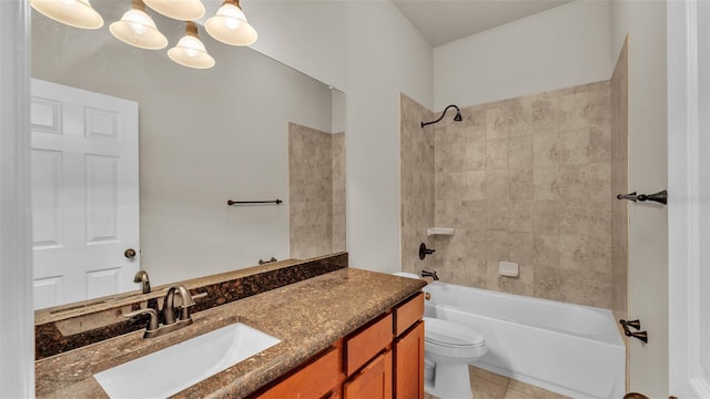 full bathroom featuring vanity, tile patterned floors, toilet, and tiled shower / bath