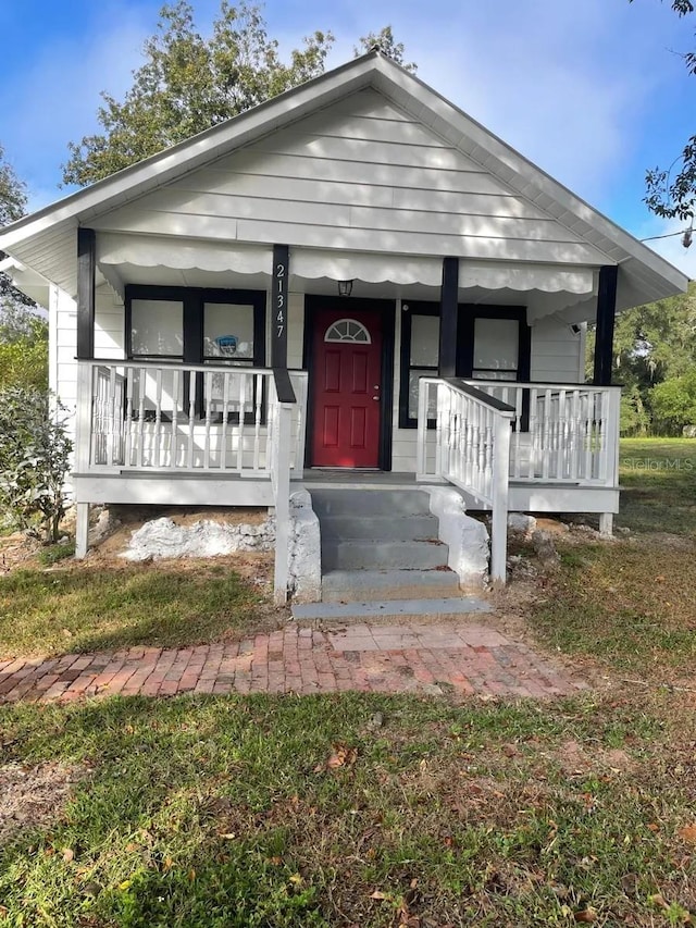 bungalow-style home with a porch and a front yard