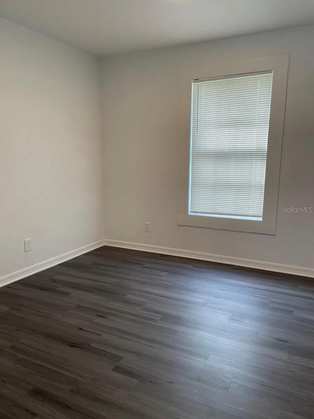 empty room with dark wood-type flooring