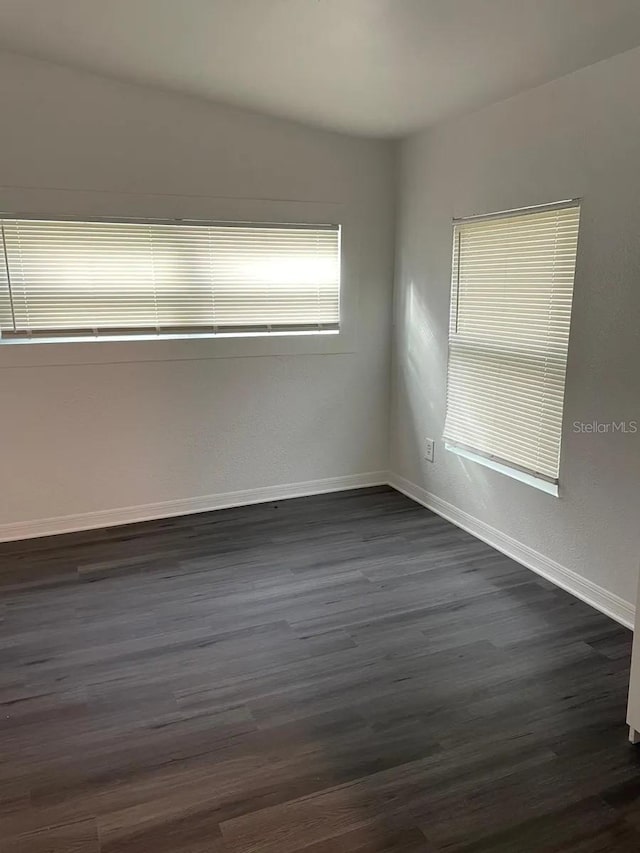 unfurnished room featuring dark hardwood / wood-style flooring