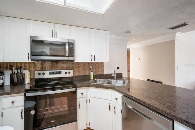 kitchen featuring white cabinetry, sink, tasteful backsplash, and stainless steel appliances