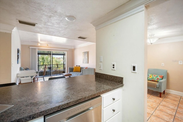 kitchen featuring dishwasher, ornamental molding, white cabinets, and a textured ceiling