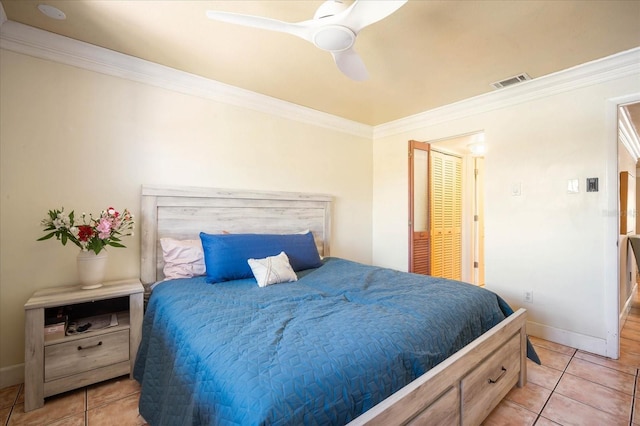 bedroom with crown molding, ceiling fan, and light tile patterned floors