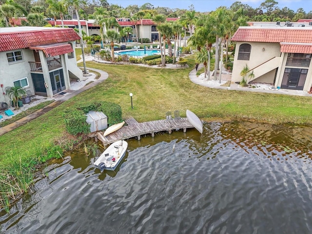 dock area with a water view and a lawn