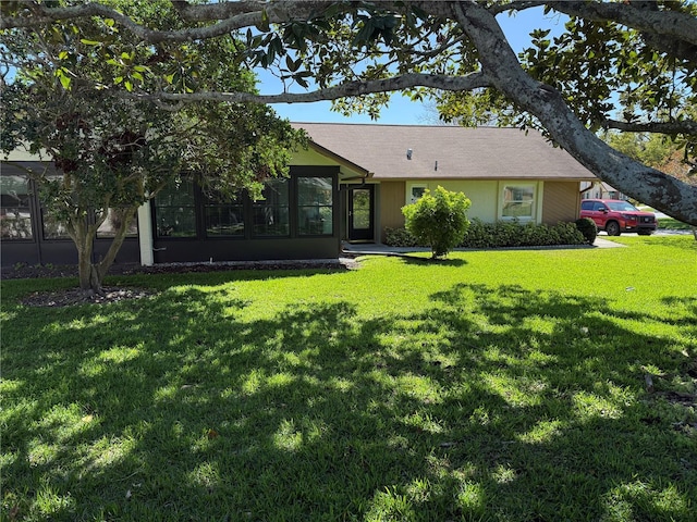 ranch-style home with a front lawn