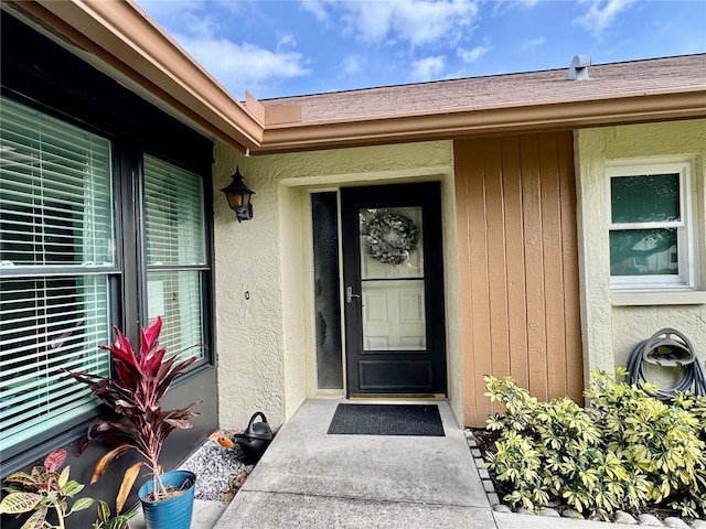 entrance to property with stucco siding