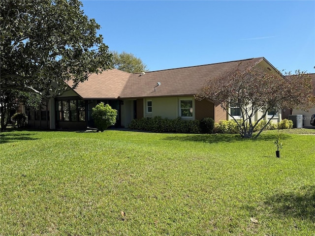 single story home featuring central AC, a front lawn, and stucco siding