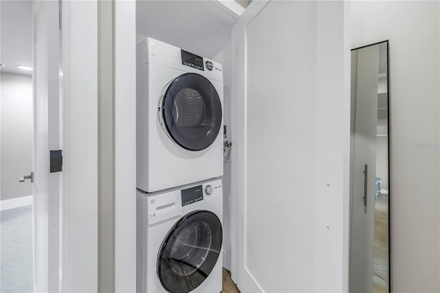 laundry area with stacked washer and dryer