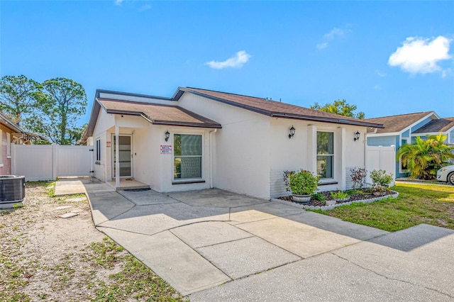 ranch-style home with a patio area and central air condition unit