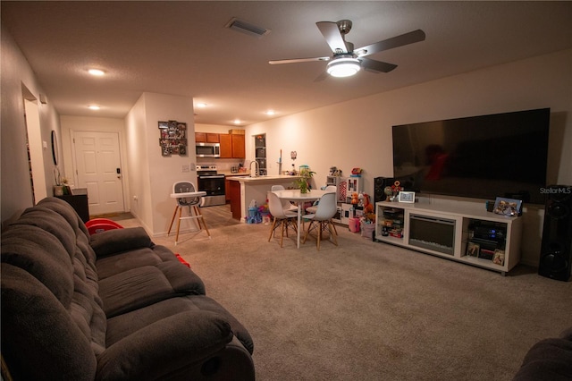 living room with recessed lighting, ceiling fan, visible vents, and light colored carpet