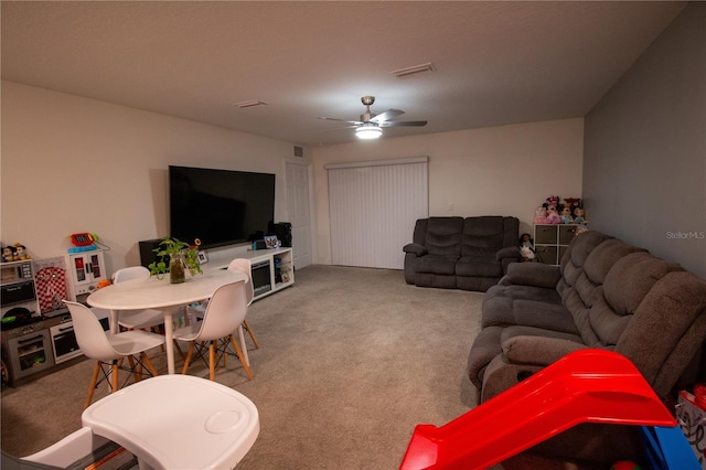 living room with ceiling fan and carpet flooring