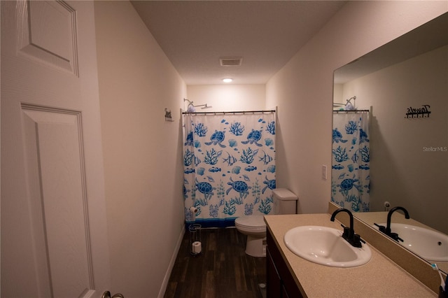 full bathroom with toilet, a shower with shower curtain, wood finished floors, visible vents, and vanity