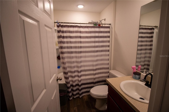 full bathroom with curtained shower, vanity, toilet, and wood finished floors