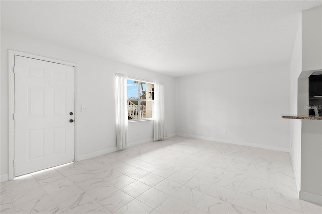 unfurnished living room featuring a textured ceiling