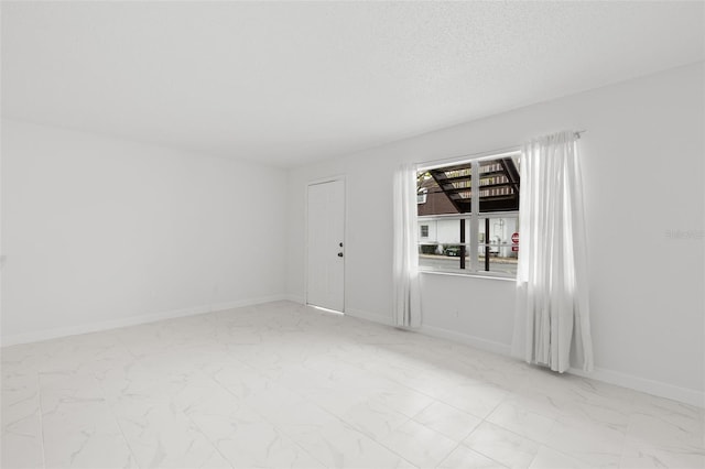 spare room with a textured ceiling