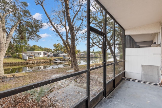 unfurnished sunroom with a wealth of natural light and a water view