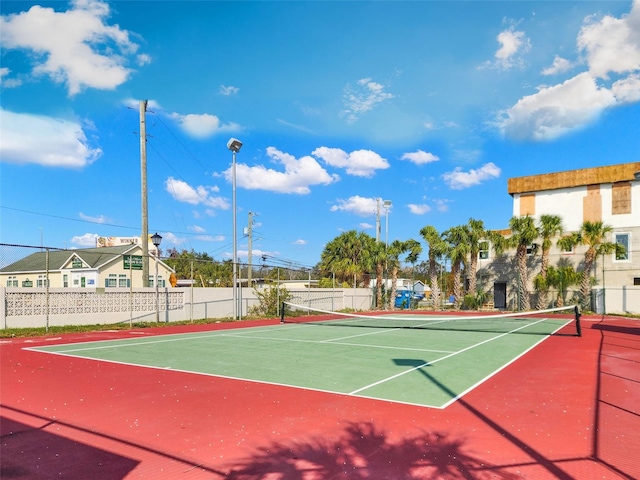 view of tennis court featuring basketball hoop