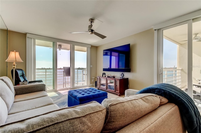 living room featuring a wall of windows and ceiling fan