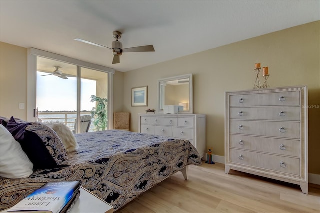 bedroom featuring access to outside, light hardwood / wood-style floors, and ceiling fan