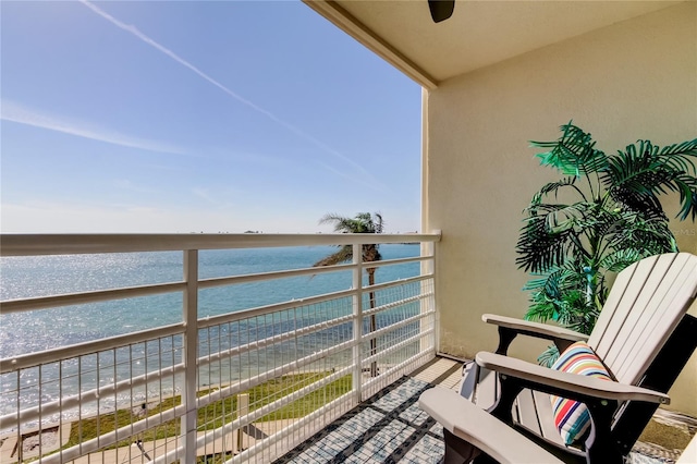 balcony featuring a water view and a view of the beach