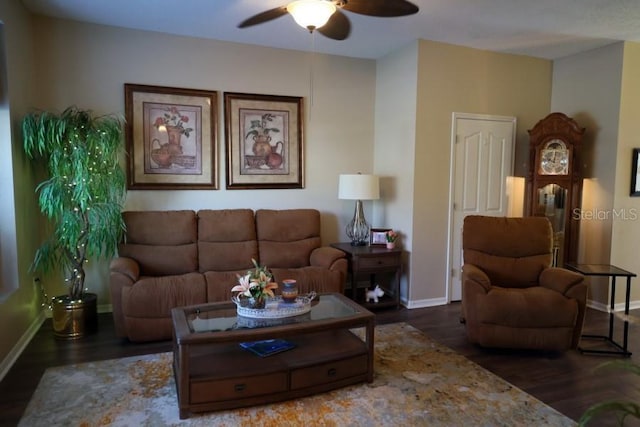 living room featuring dark hardwood / wood-style floors and ceiling fan