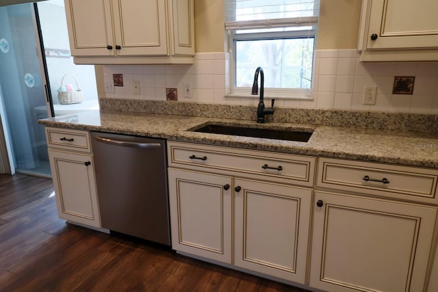 kitchen featuring light stone counters, sink, dark wood-type flooring, and stainless steel dishwasher