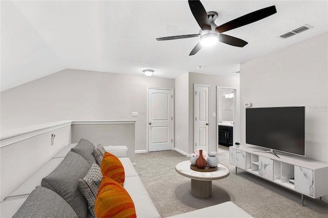 carpeted living area with a ceiling fan, baseboards, and vaulted ceiling
