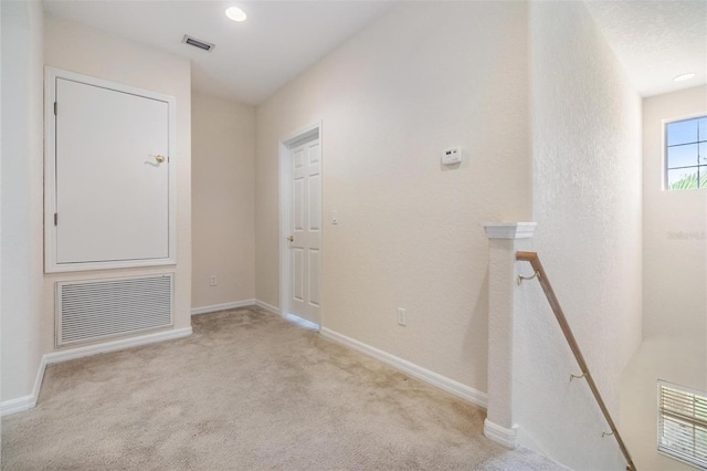 corridor with light colored carpet