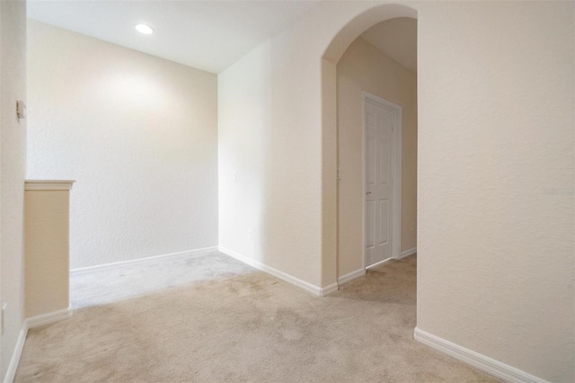 hallway with light colored carpet