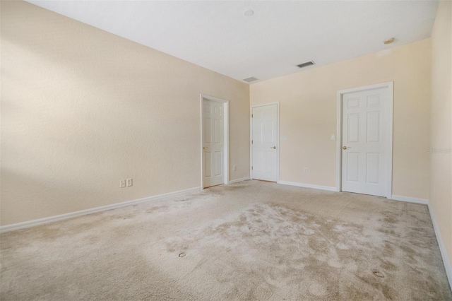 unfurnished bedroom featuring light carpet