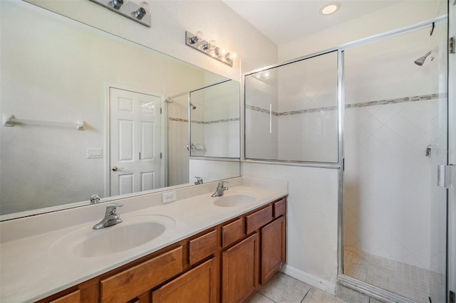 bathroom with walk in shower, tile patterned floors, and vanity