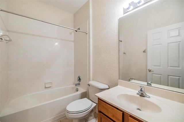 full bathroom with vanity, tiled shower / bath combo, and toilet