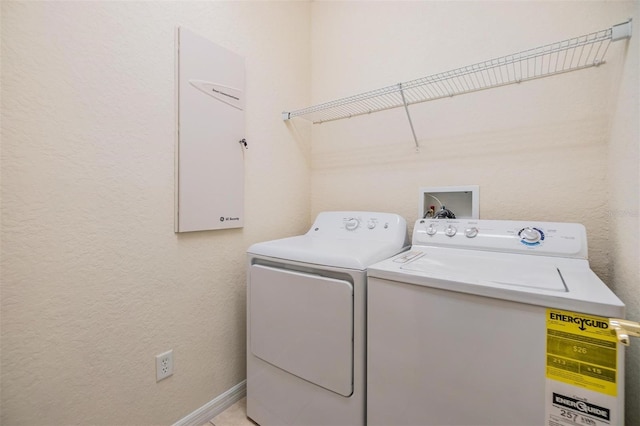 clothes washing area with separate washer and dryer