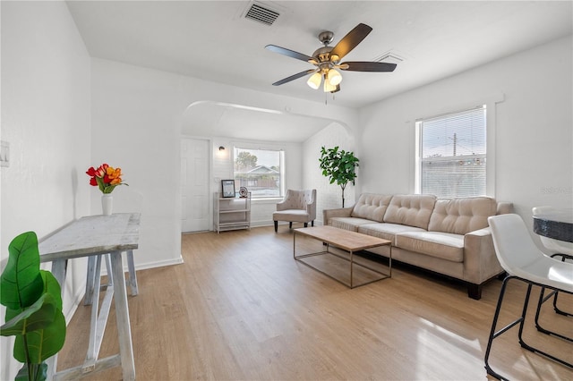 living room featuring ceiling fan and light wood-type flooring