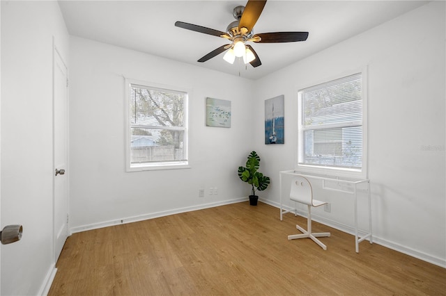 unfurnished room featuring plenty of natural light, ceiling fan, and light hardwood / wood-style flooring