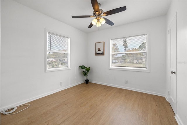 unfurnished room with ceiling fan and light wood-type flooring