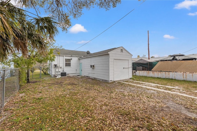 rear view of house featuring a lawn and central air condition unit