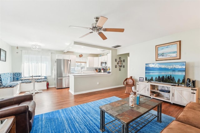 living room with ceiling fan and hardwood / wood-style floors