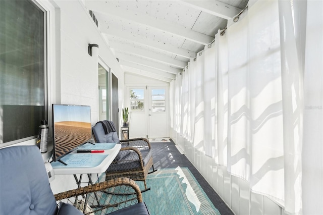 sunroom with vaulted ceiling with beams