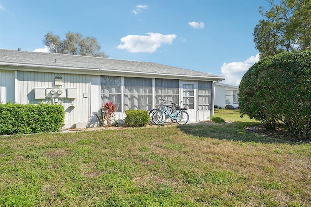 rear view of house featuring a lawn