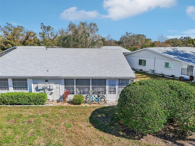 rear view of house featuring a yard