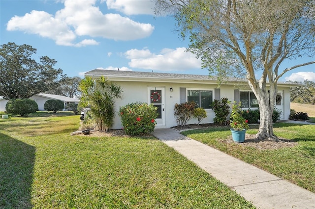 ranch-style house with a front lawn