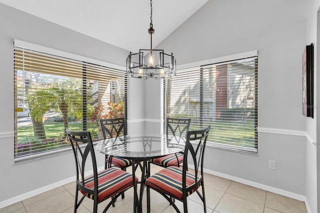 tiled dining room featuring lofted ceiling, a chandelier, and a healthy amount of sunlight